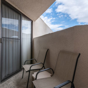 First floor patio of condo with two patio chairs