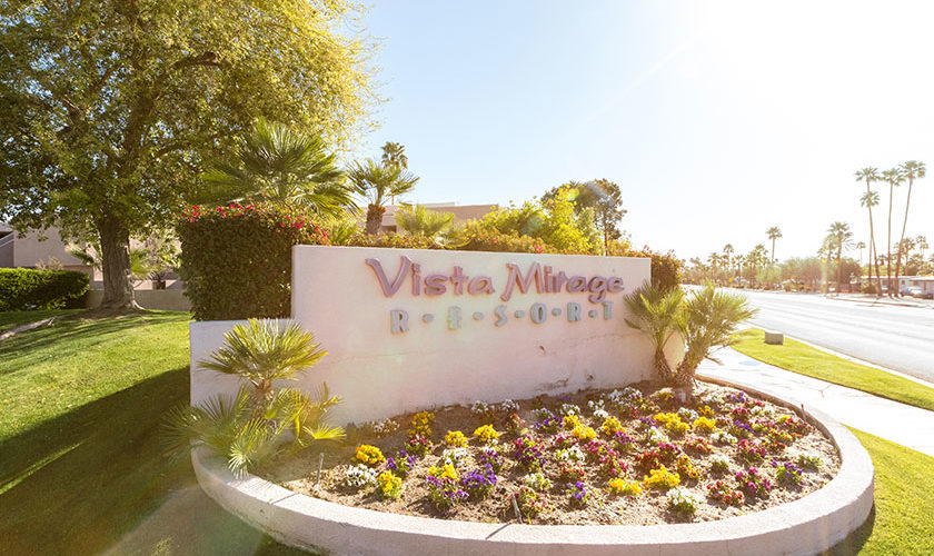 Vista Mirage Resort marquee sign with flowers, and palm trees