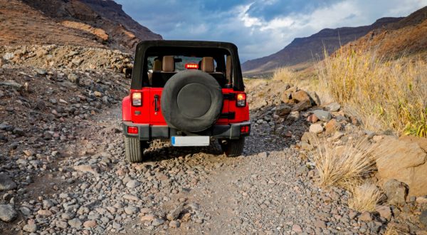 red jeep driving in desert