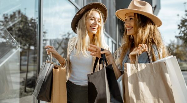 girls shopping together carrying their bags